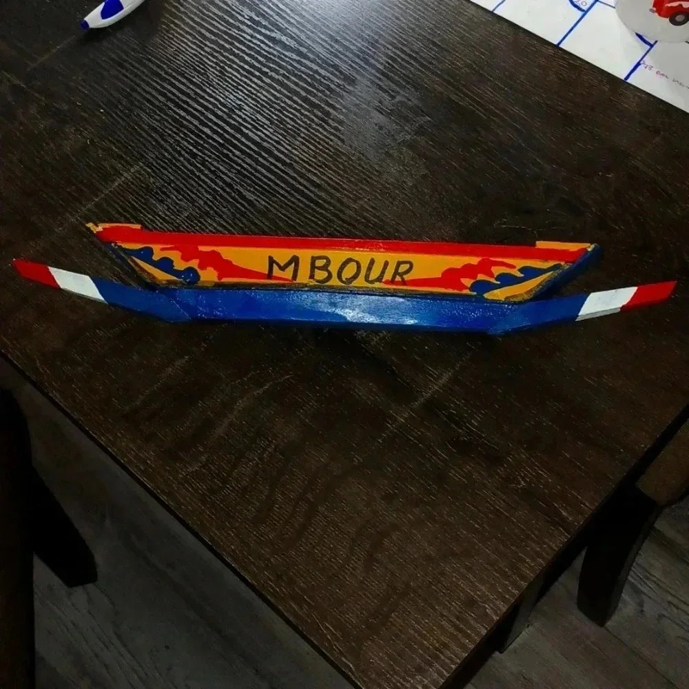 Hand crafted colorful boat with paddle..about 9 inches